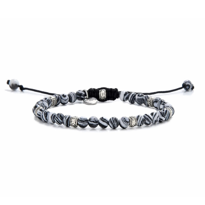 Full view of men’s malachite bracelet featuring striped black and white beads with silver spacers.