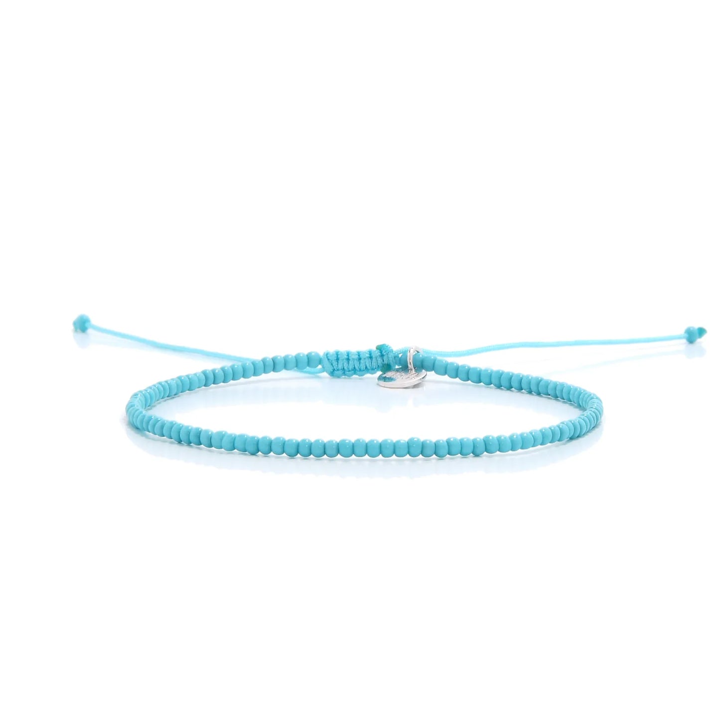 Mens Beaded Bracelets shown in full view with turquoise seed beads with silver charm and adjustable cord
