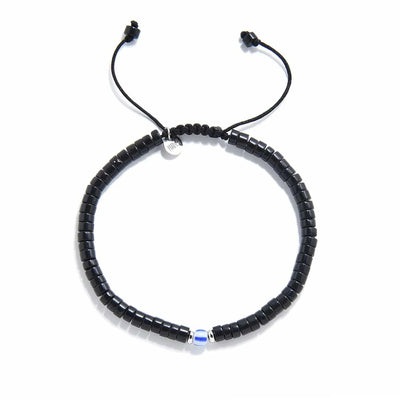 Mens Black Pearl Bracelet shown from above with matte black clay beads with blue accent bead and round bracelet shape