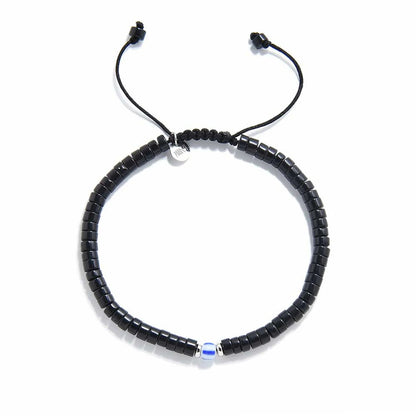 Mens Black Pearl Bracelet shown from above with matte black clay beads with blue accent bead and round bracelet shape