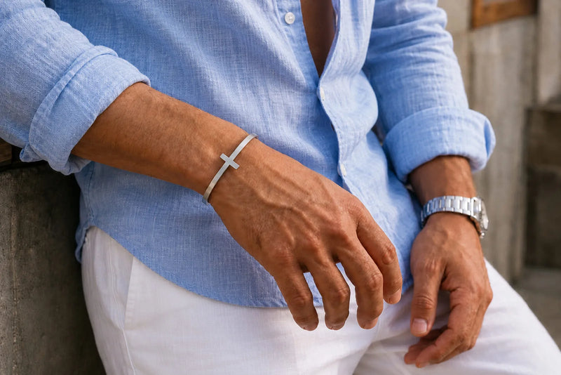 Men’s stainless steel cross bracelet styled with a blue linen shirt