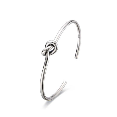 Mens Cuff Bracelets shown in side profile with open cuff shape and raised knot centerpiece