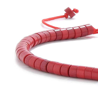 Detailed view of Mens Red String Bracelet with red clay beads with silver charm, clay bead texture, and cord knot