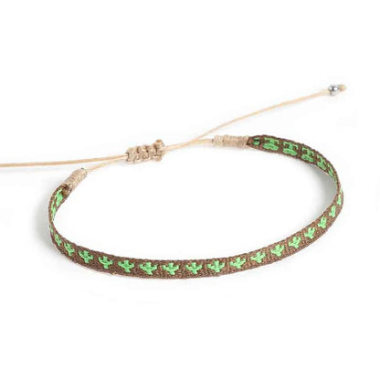 Mens rope bracelet shown from above with green cactus embroidery and sliding knot cord closure