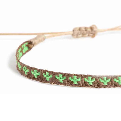 Detailed view of mens rope bracelet texture with green cactus embroidery on brown woven cord