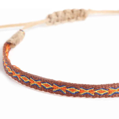 Close-up of Mens Rope Bracelets with brown woven band, orange diamonds, and blue accents
