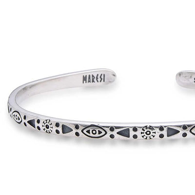 Close-up of Mens Stainless Steel Bracelets with eye, sun, triangle, and dot engravings