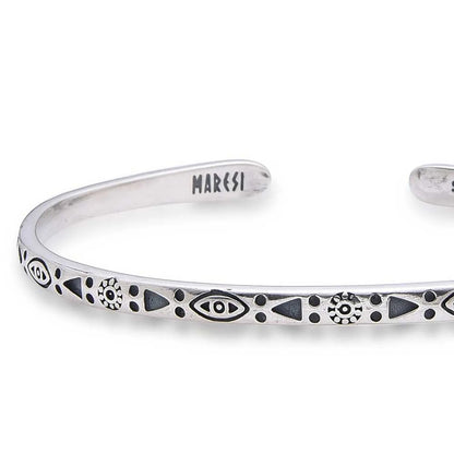 Close-up of Mens Stainless Steel Bracelets with eye, sun, triangle, and dot engravings