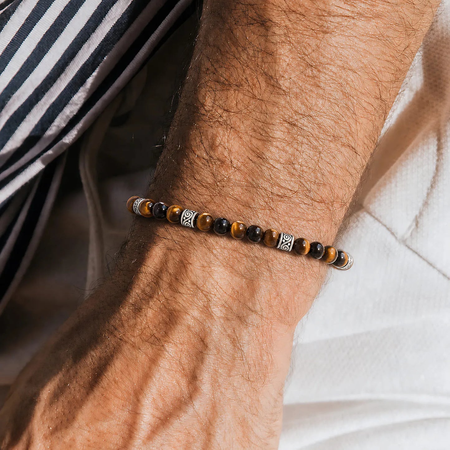 Men's Tiger Eye Bracelet worn on a wrist with beaded design and adjustable cord