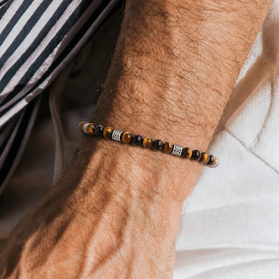 Men's Tiger Eye Bracelet worn on a wrist with beaded design and adjustable cord
