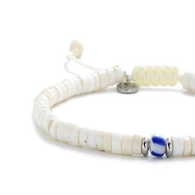 Close-up of Mens White Bracelet showing white clay beads with blue accent bead, silver charm, and cord closure