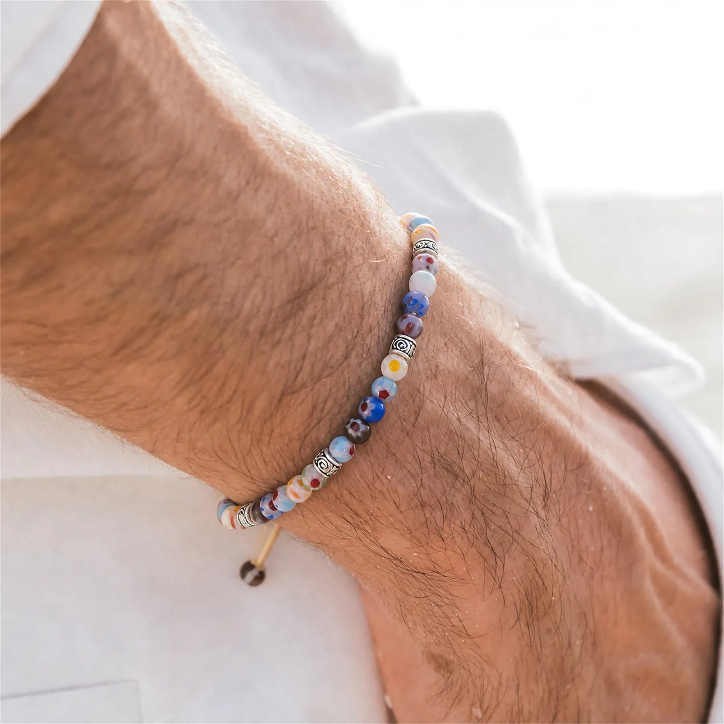 Millefiori Beads worn on a wrist with beaded design and adjustable cord