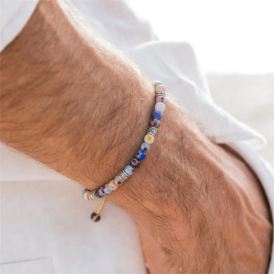 Millefiori Beads worn on a wrist with beaded design and adjustable cord