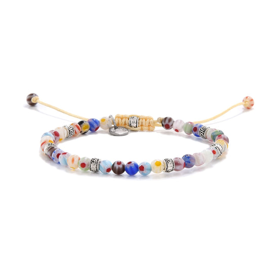 millefiori beads bracelet displayed on a white background, showcasing detailed floral glasswork.