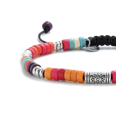Close-up of Multicolored Beaded Bracelet showing multicolor clay beads with engraved silver spacers, silver charm, and cord