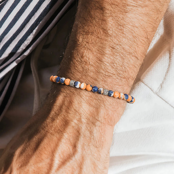 Orange Stone Bracelet worn on a wrist beside a striped shirt