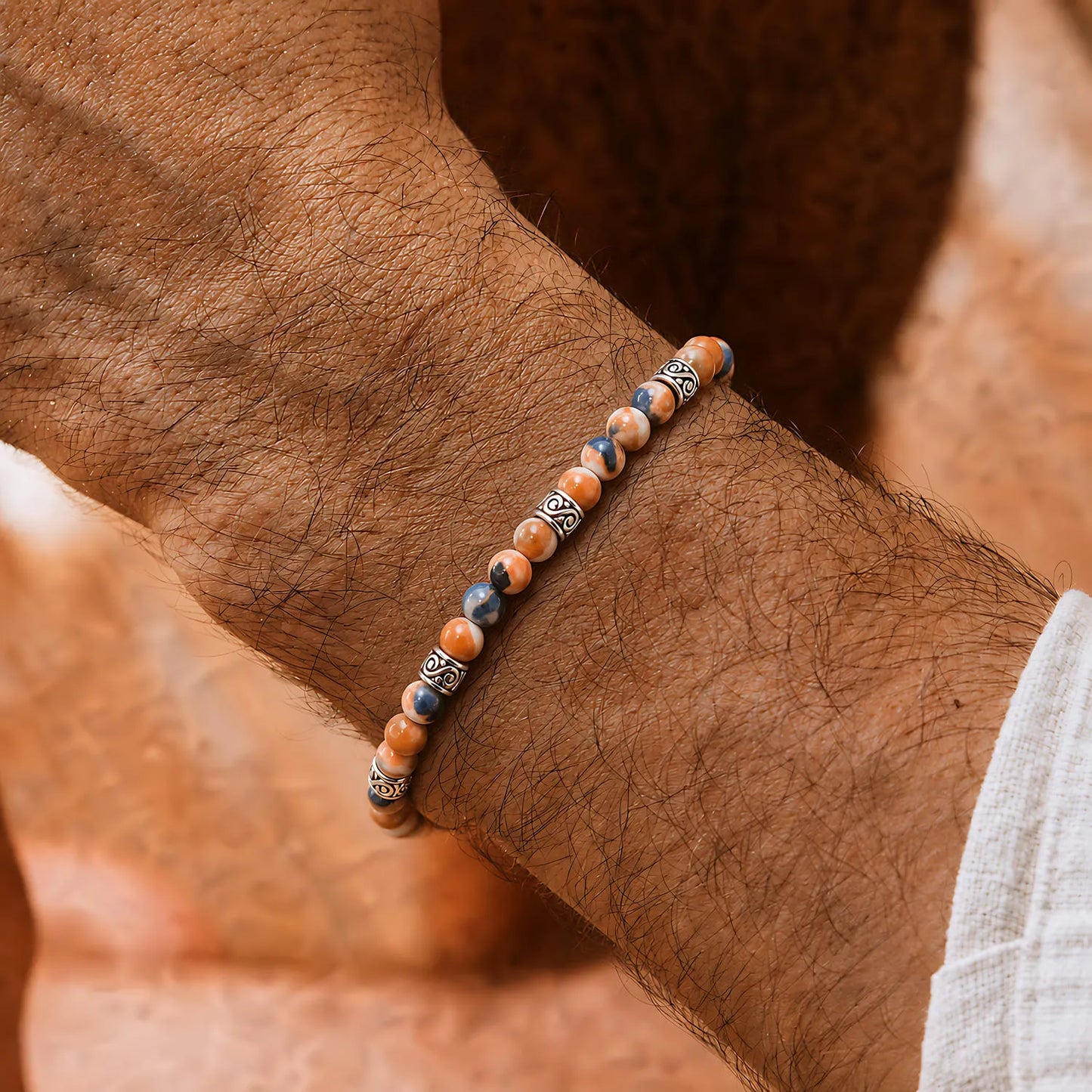 Orange Stone Bracelet worn on a wrist with beaded design and adjustable cord