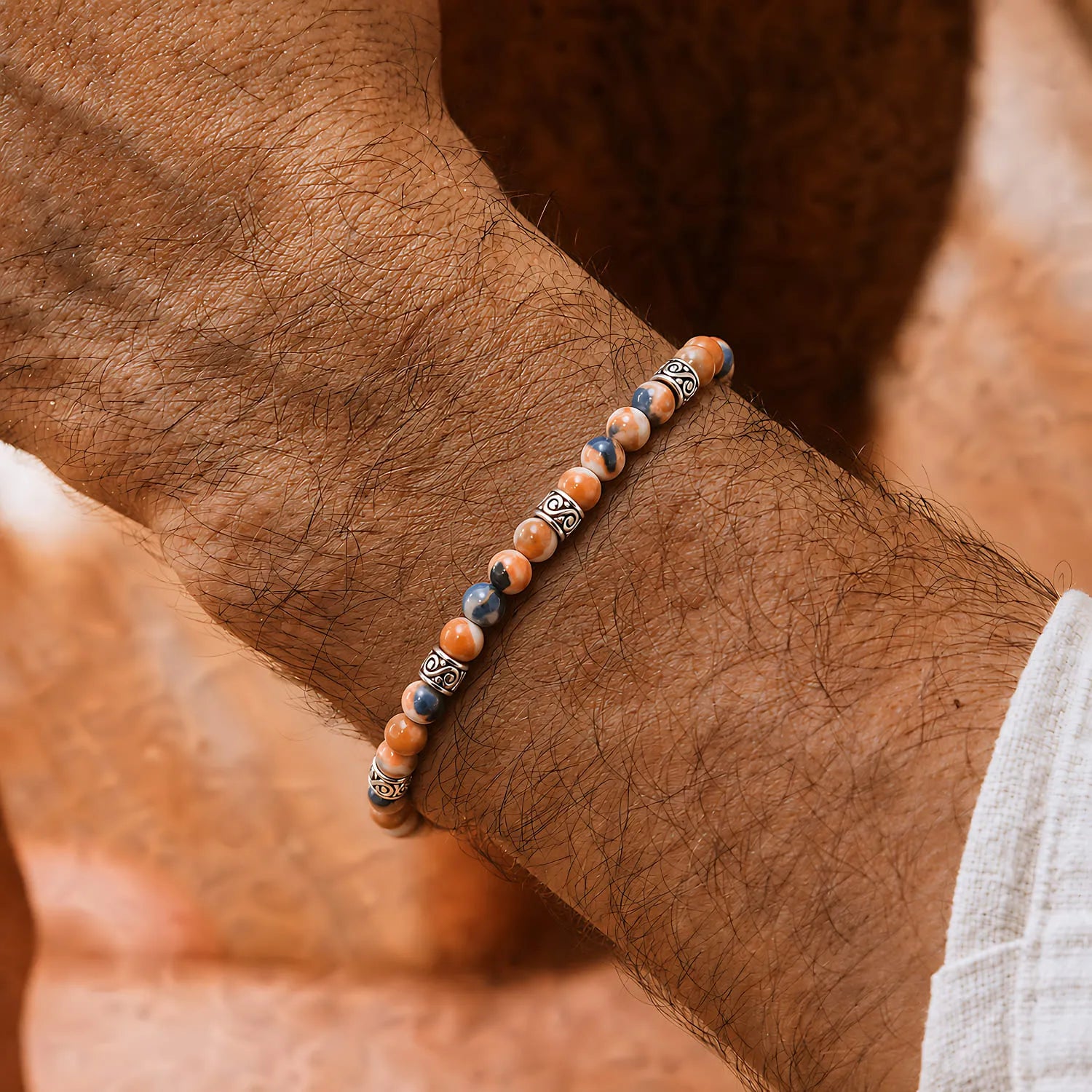Orange Stone Bracelet worn on a wrist with beaded design and adjustable cord