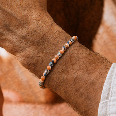 Orange Stone Bracelet worn on a wrist with beaded design and adjustable cord