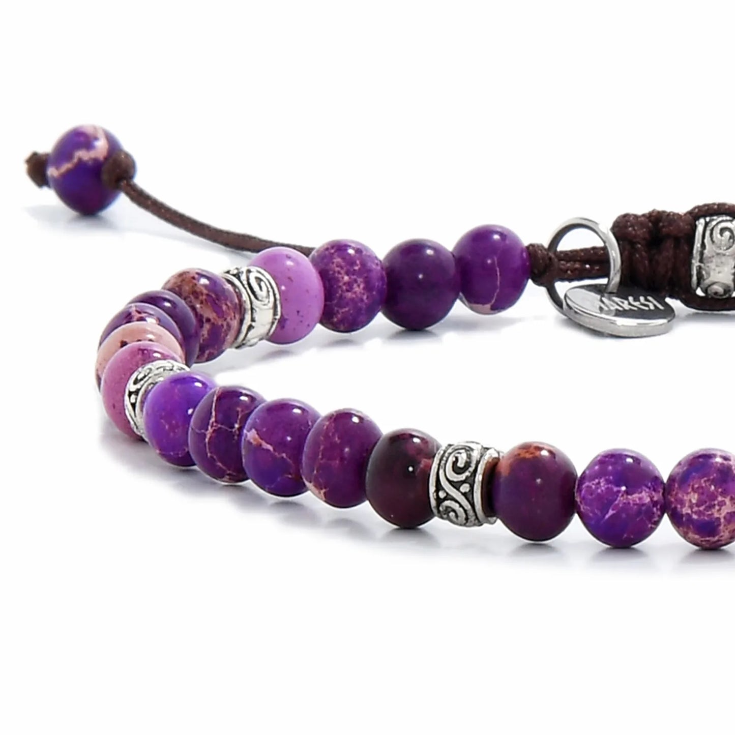 Close-up of Purple Jasper Bracelet beads with silver spacers, brown cord, and polished purple stones.
