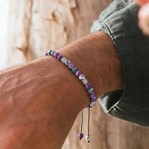 Purple Jasper Bracelet worn on a wrist with beaded design and adjustable cord