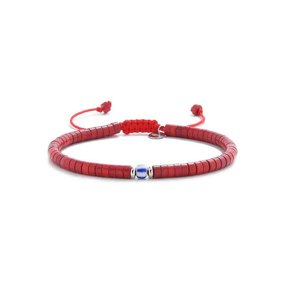red gemstone jewelry shown in full view with red clay beads with blue accent bead and adjustable cord