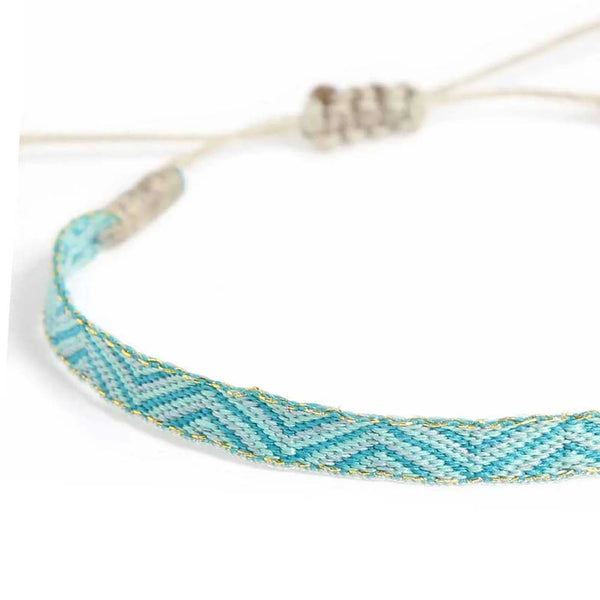 Close-up of Rope Bracelet Mens with turquoise woven band, pale blue chevrons, and gold accents
