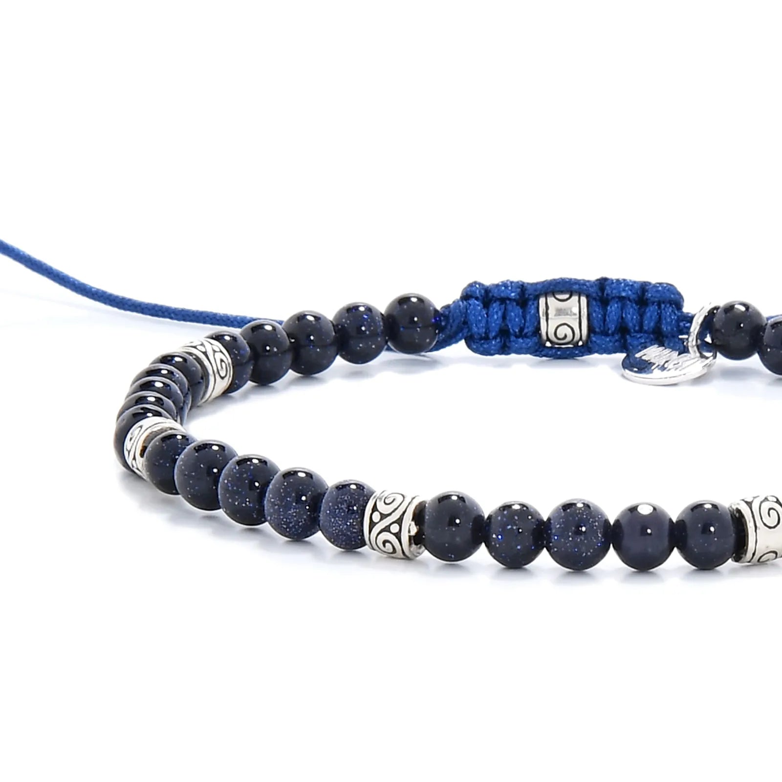Sandstone Bracelet bead detail showing glittered dark blue stones and engraved silver spacers