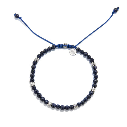 Sandstone Bracelet top view with round bead loop, blue drawcord ends, silver charm, and spacers
