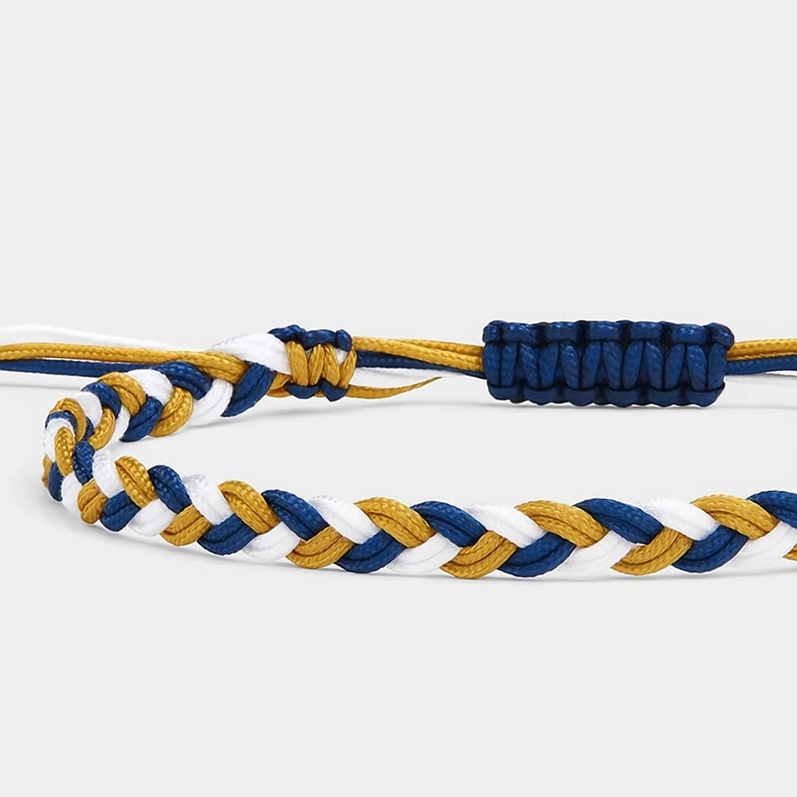 adjustable friendship bracelet close-up showing braided cord texture, adjustable knot, and charm detail