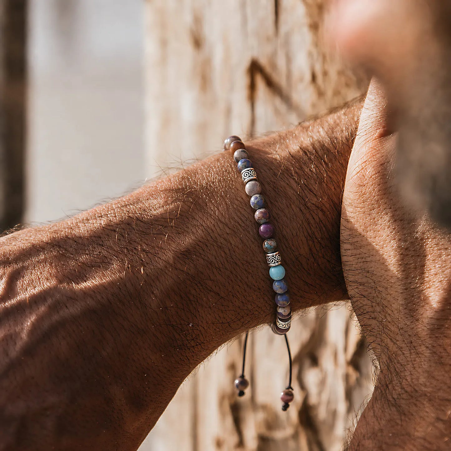 Sea Sediment Jasper Bracelet worn on a wrist against a warm wood background