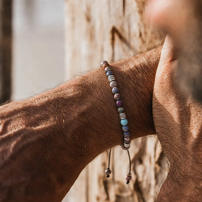 Sea Sediment Jasper Bracelet worn on a wrist against a warm wood background