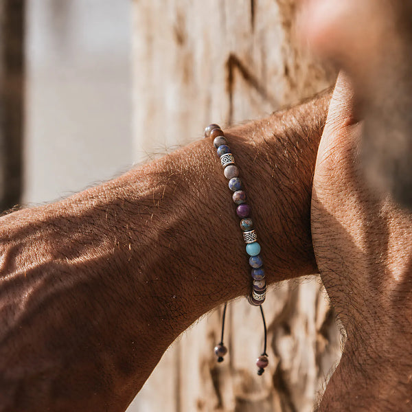 Sea Sediment Jasper Bracelet worn on a wrist against a warm wood background