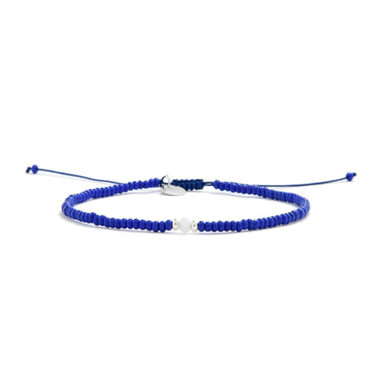 Seed Bead Bracelet Ideas shown in full view with blue seed beads with white accent beads and adjustable cord