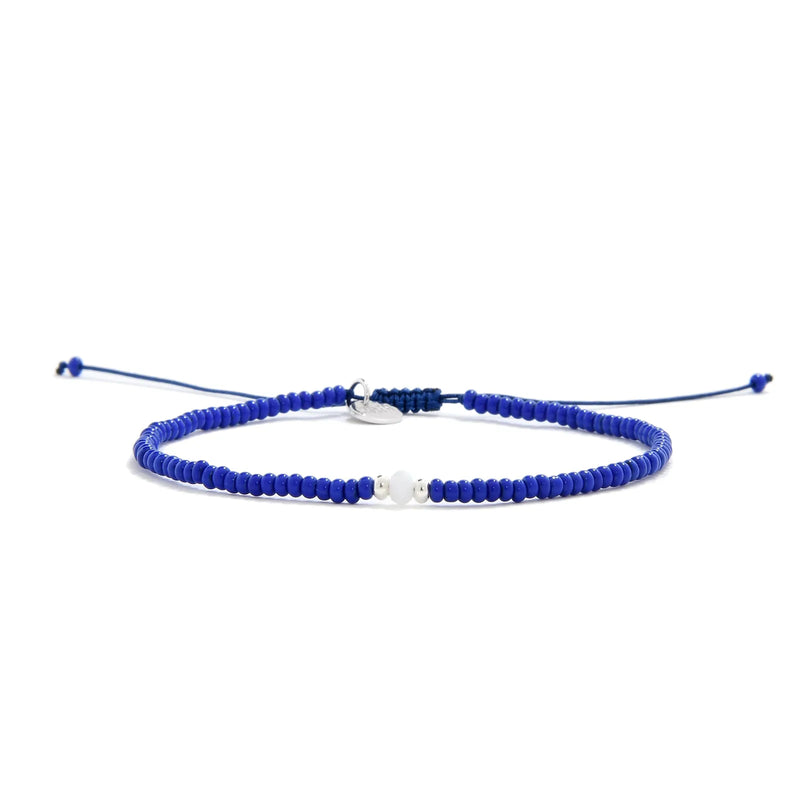 Seed Bead Bracelet Ideas shown in full view with blue seed beads with white accent beads and adjustable cord