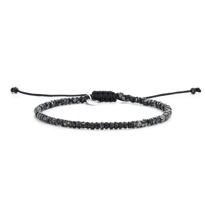 Seed Bead Bracelets shown in full view with black and gray Picasso seed beads and adjustable cord