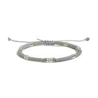 Shamballa Bracelet shown in full view with gray clay beads with engraved silver spacers and adjustable cord