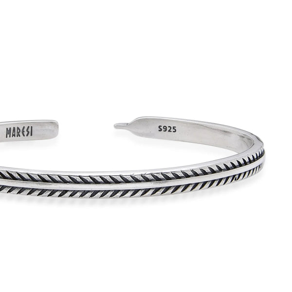 Close-up of Silver Mens Bracelet with feather engraving, polished edges, and stamped inner end
