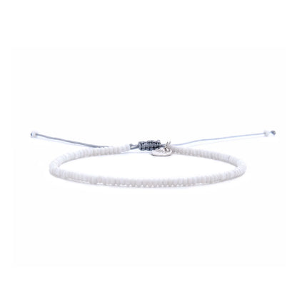 Small Beaded Bracelets shown in full view with white seed beads with gray cord and adjustable cord