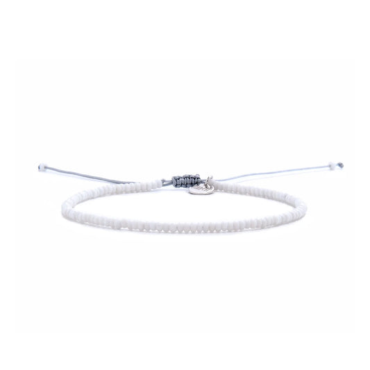 Small Beaded Bracelets shown in full view with white seed beads with gray cord and adjustable cord