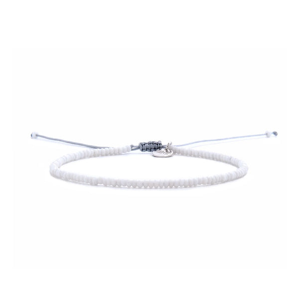 Small Beaded Bracelets shown in full view with white seed beads with gray cord and adjustable cord