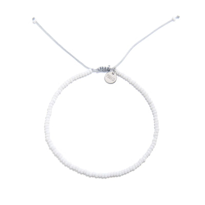 Small Beaded Bracelets shown from above with white seed beads with gray cord and round bracelet shape