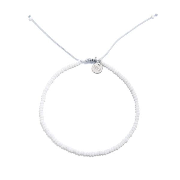 Small Beaded Bracelets shown from above with white seed beads with gray cord and round bracelet shape