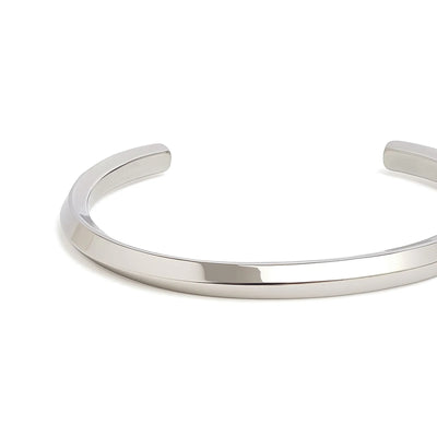 Close-up of stainless steel bracelet for men showing smooth polished band and rounded open ends