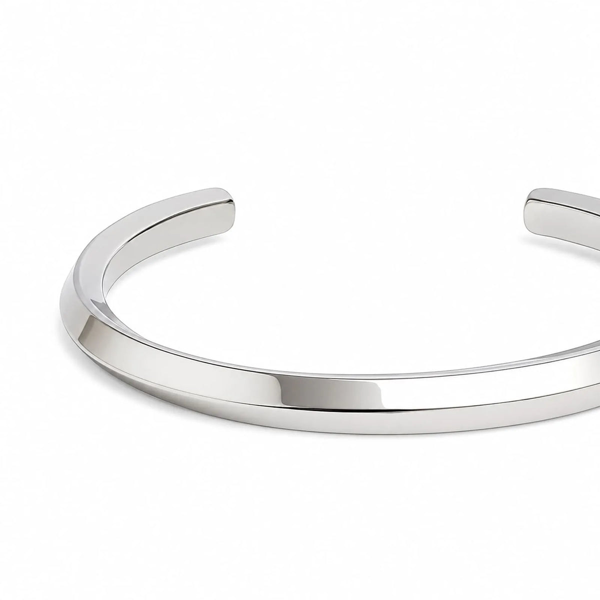 Close-up of stainless steel bracelet for men showing smooth polished band and rounded open ends