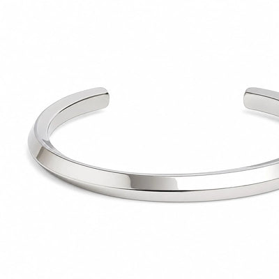 Close-up of stainless steel bracelet for men showing smooth polished band and rounded open ends