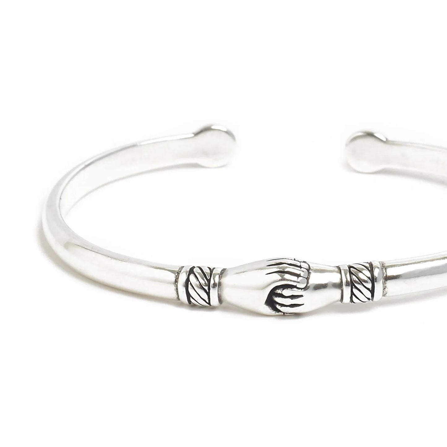 Close-up of Stainless Steel Bracelets cuff showing handshake centerpiece and carved line details
