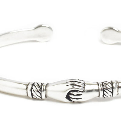 Detailed view of Stainless Steel Bracelets cuff with polished metal, handshake motif, and etching