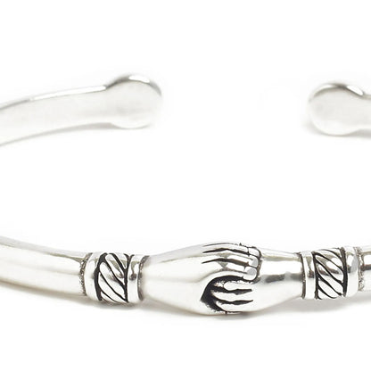 Detailed view of Stainless Steel Bracelets cuff with polished metal, handshake motif, and etching