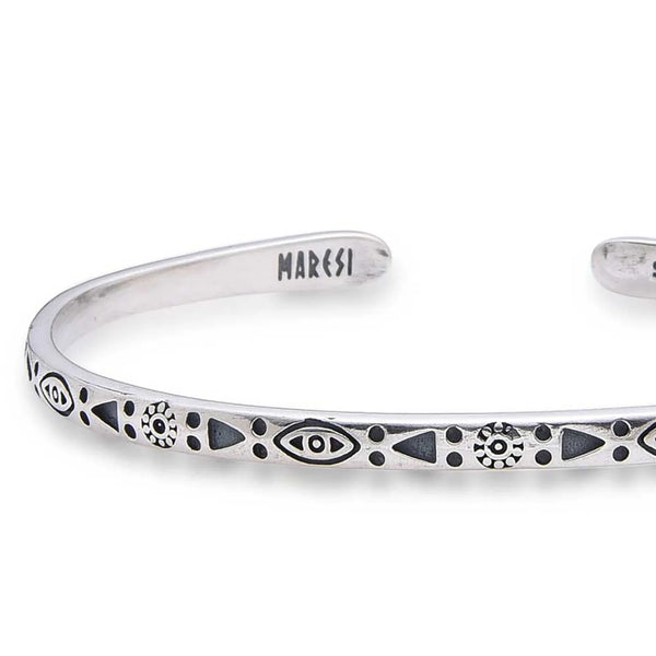 Close-up of Sterling Silver Mens Bracelet with eye, sun, triangle, and dot engravings